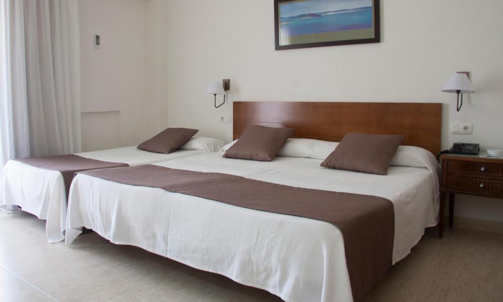 Postel nebo postele na pokoji v ubytování Hotel Sicania