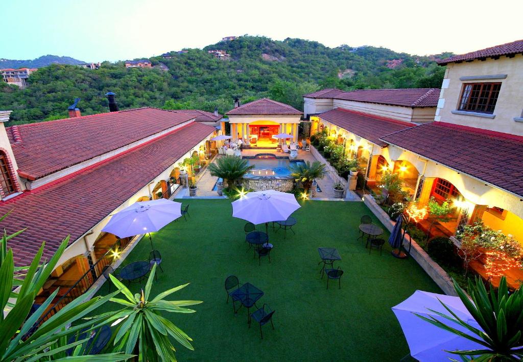 an overhead view of a courtyard with tables and umbrellas at La Villa Vita in Nelspruit