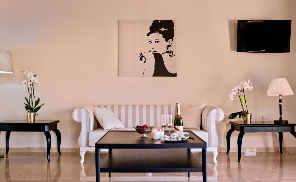 a living room with a couch and two tables at Ornella Beach Resort & Villas in Syvota