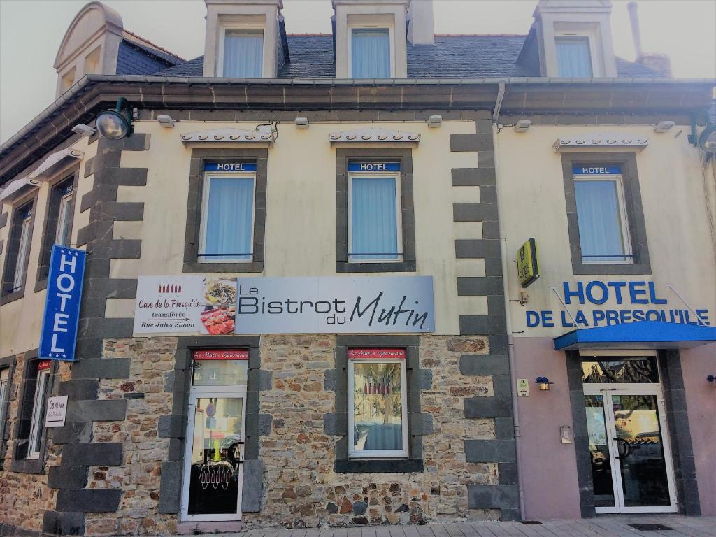 a hotel building with a sign on the front of it at Hôtel de la Presqu'ile in Crozon