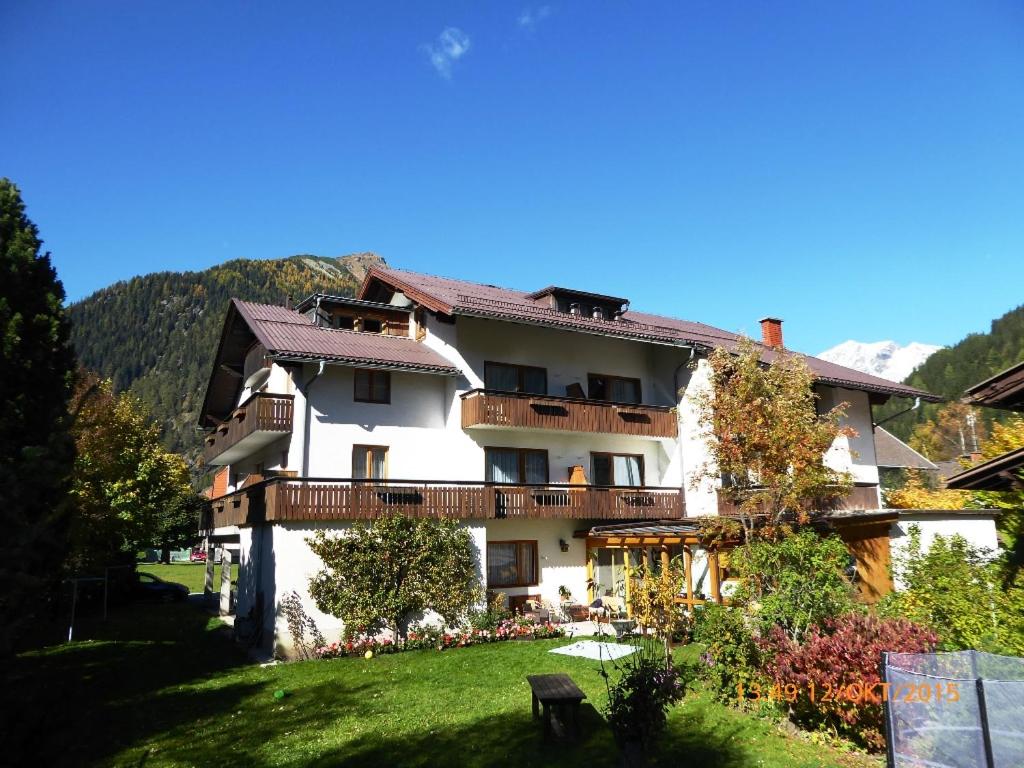 a large white building with a balcony at Gästehaus Truskaller in Mallnitz