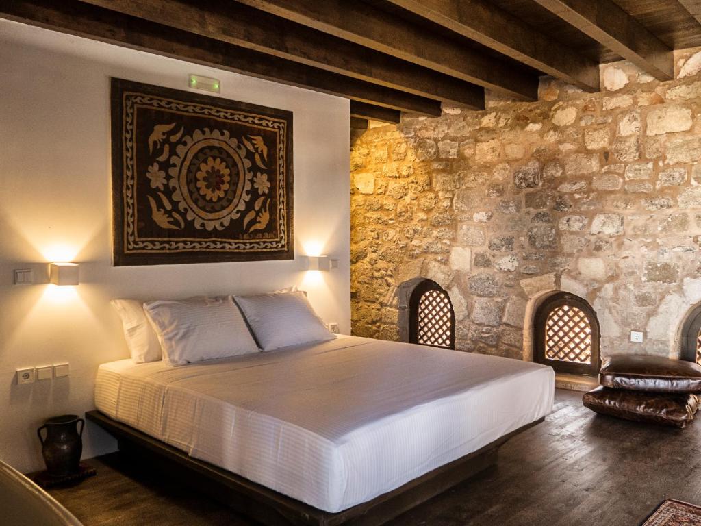 a bedroom with a bed and a fireplace at Trinity Boutique Hotel in Rhodes Town