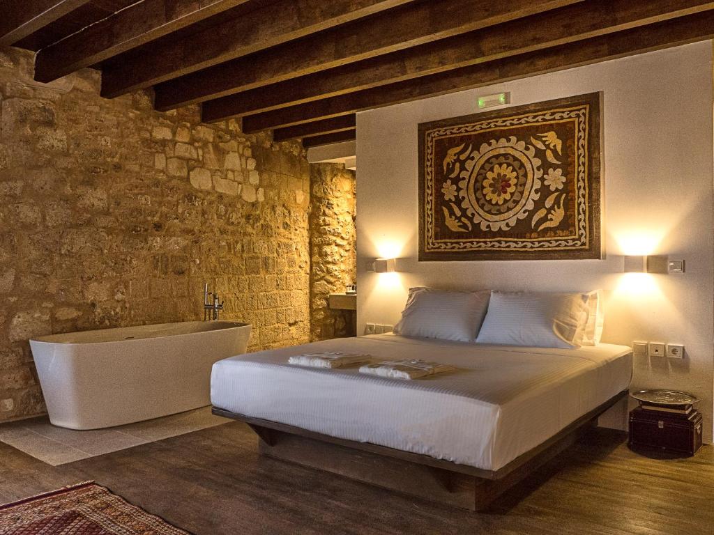 a bedroom with a bed and a bath tub at Trinity Boutique Hotel in Rhodes Town