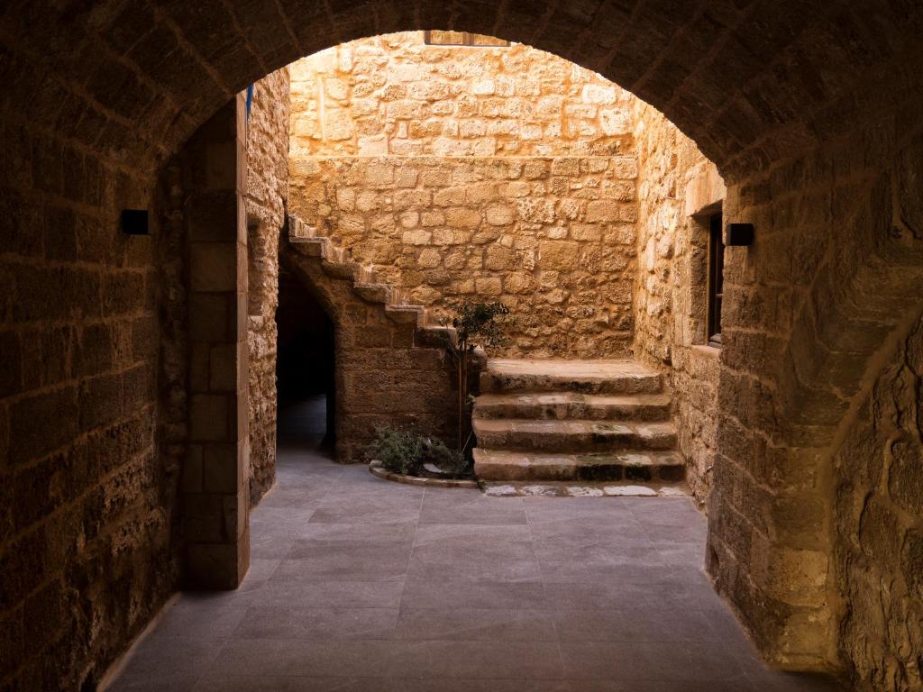 an alley way in an old stone building with stairs at Trinity Boutique Hotel in Rhodes Town