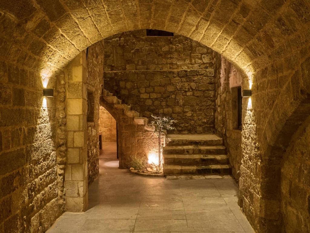 a stone tunnel with stairs in a castle at Trinity Boutique Hotel in Rhodes Town