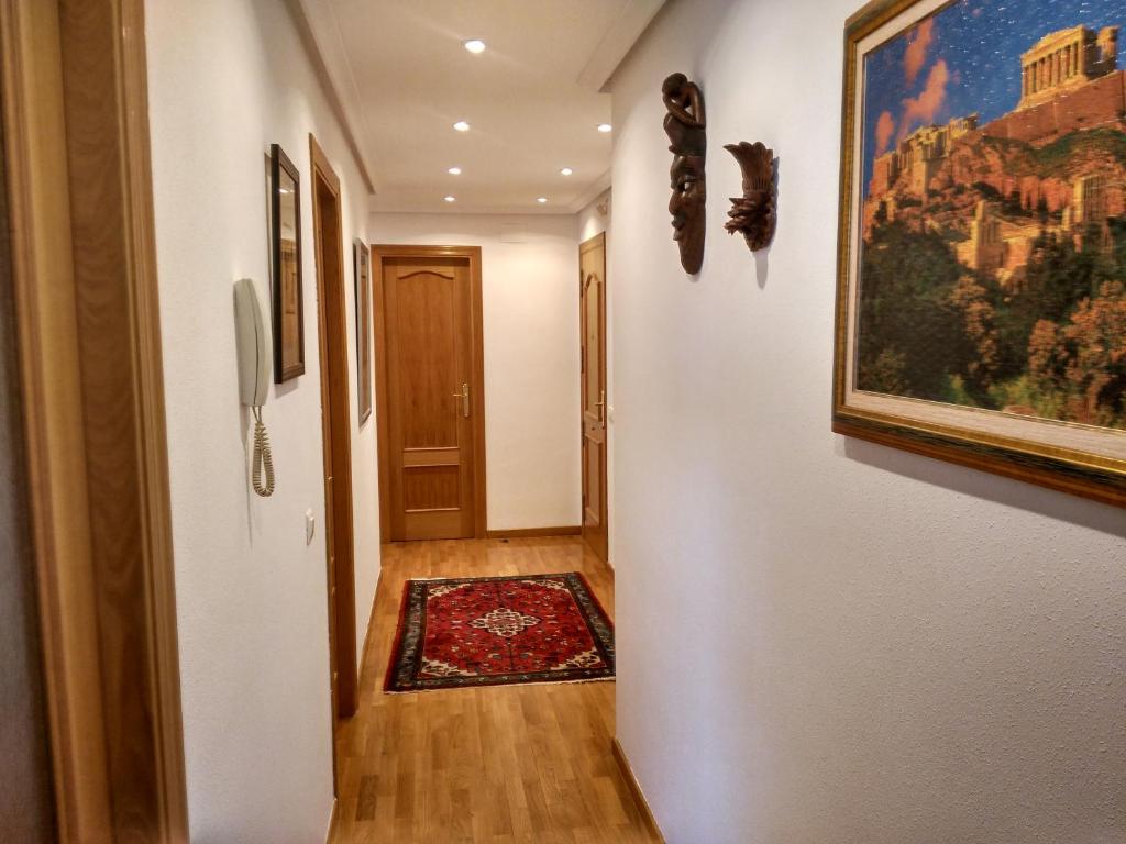 a hallway with a painting on the wall and a door at Vivienda Briviesca La Vega in Briviesca