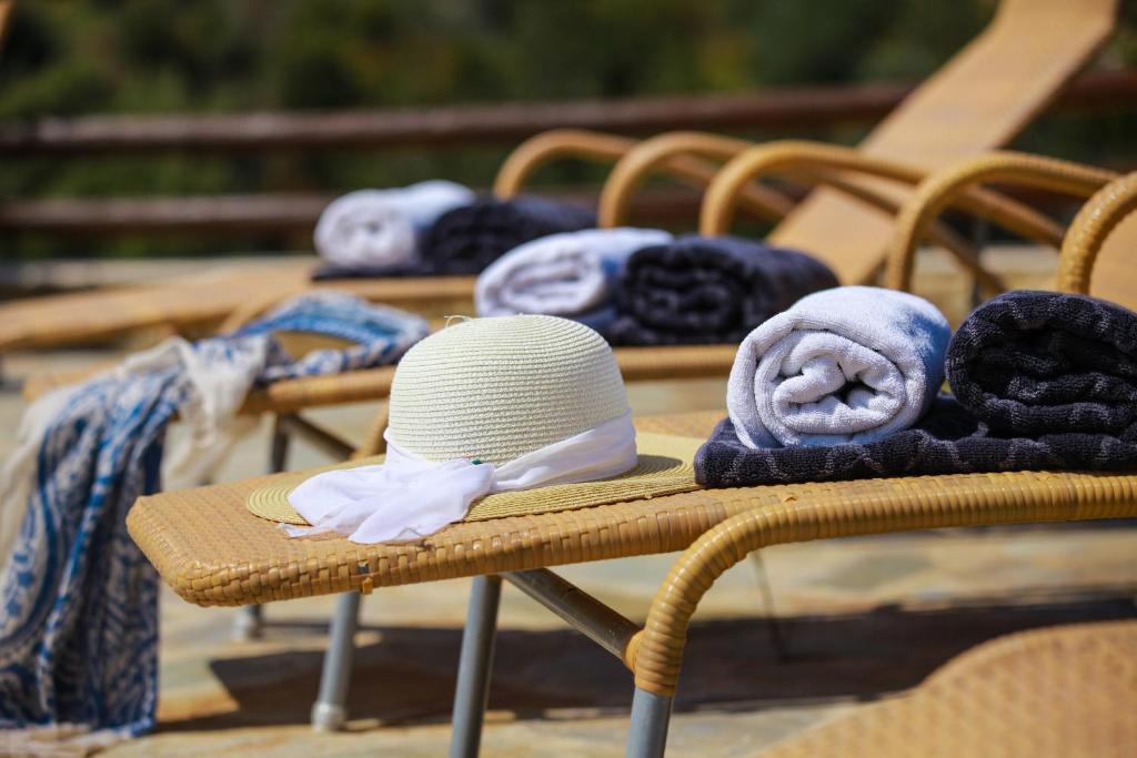 a row of chairs with hats and towels on them at Theos Club Villas in Polis Chrysochous