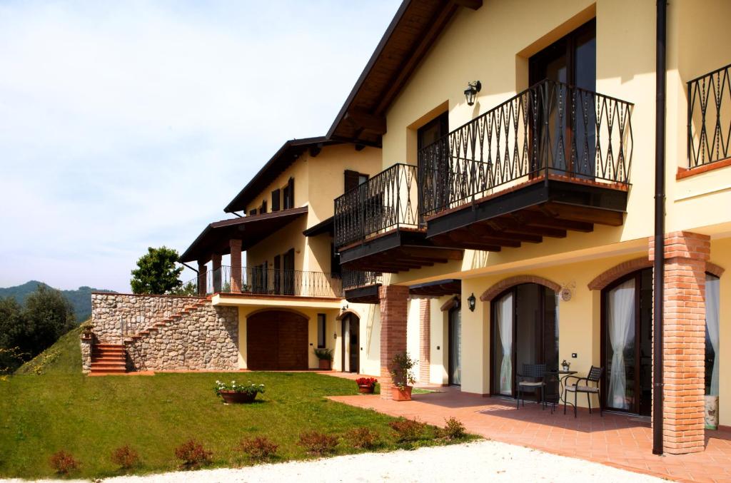 a large house with balconies and a lawn at Agriturismo Il Casale Del Lago in Gardone Riviera