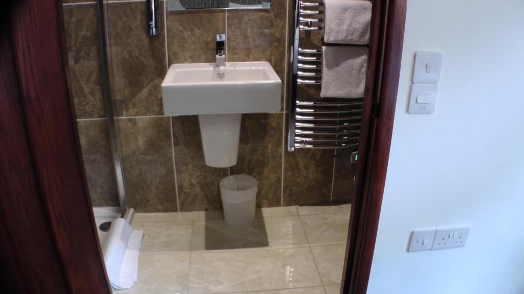 a bathroom with a sink and a toilet at Bay Lodge in Birchington