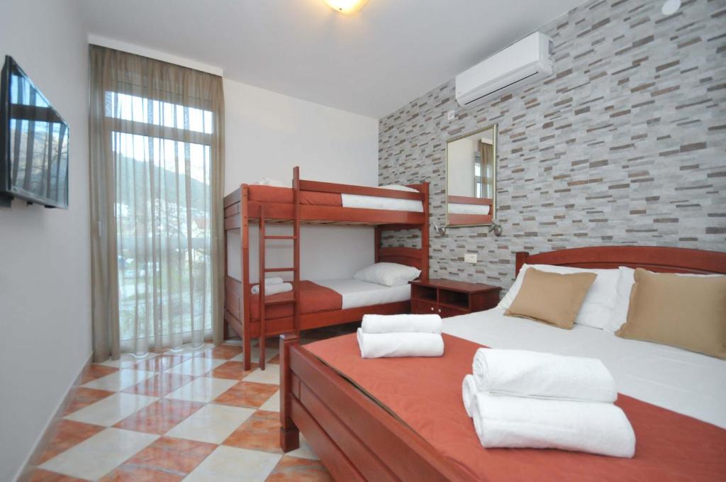 a bedroom with two beds and a bunk bed at D&D Apartments 3 in Budva