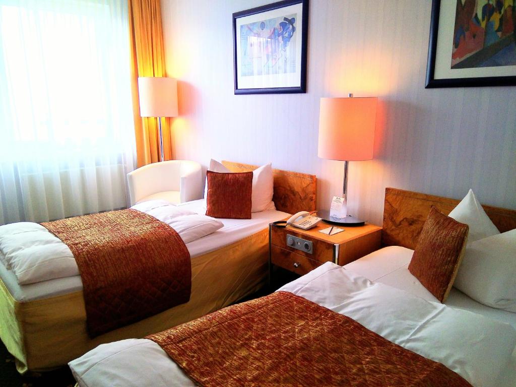 Postel nebo postele na pokoji v ubytování Alexa Hotel
