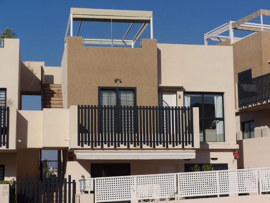 a house with a black fence in front of it at Residencial Sabrina Penthouse in Playas de Orihuela