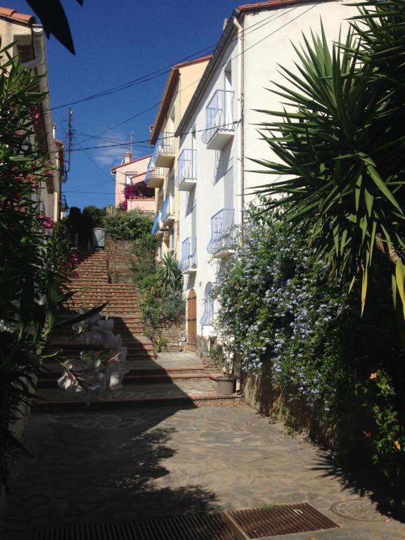 an alley with stairs leading up to a white building at Maison Banyuls in Banyuls-sur-Mer