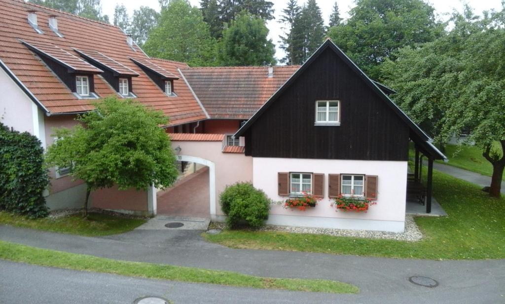 a house with a black and white at Haus am See in Litschau