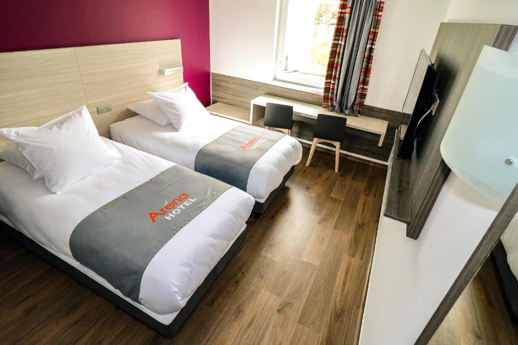 Postel nebo postele na pokoji v ubytování Hotel Arena Toulouse