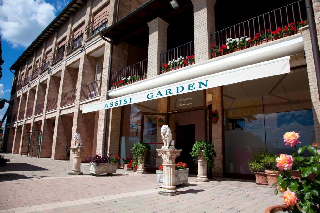 a building with a sign that reads assist carrer at Assisi Garden in Assisi