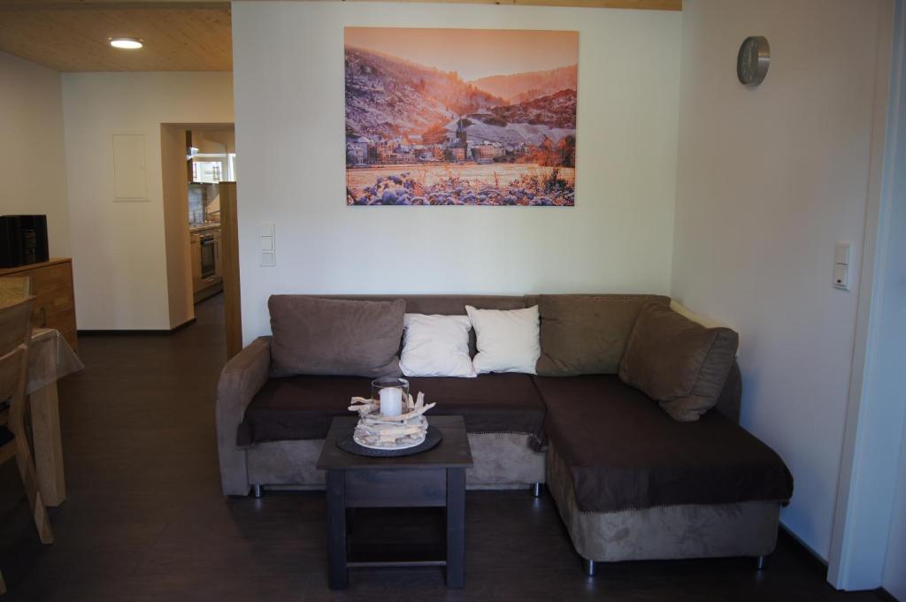 a living room with a couch and a table at Wein- & Ferienhaus Jörg Weirich in Bernkastel-Kues