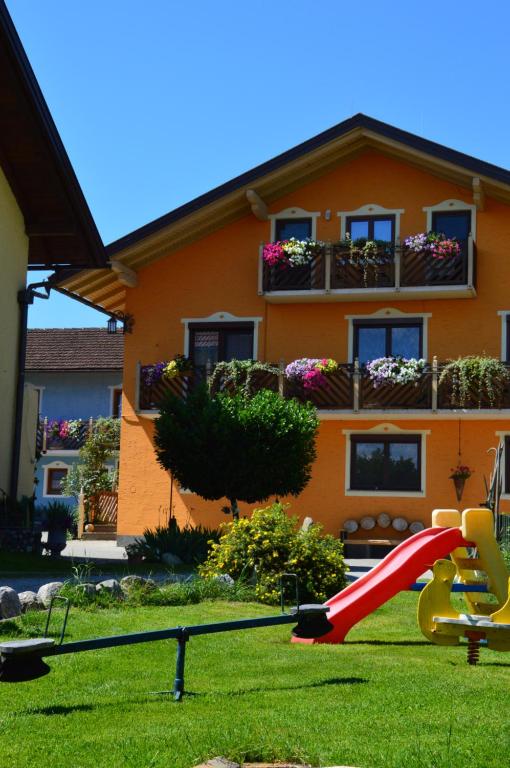 a playground in front of a house with a slide at Pimperlhof in Franking