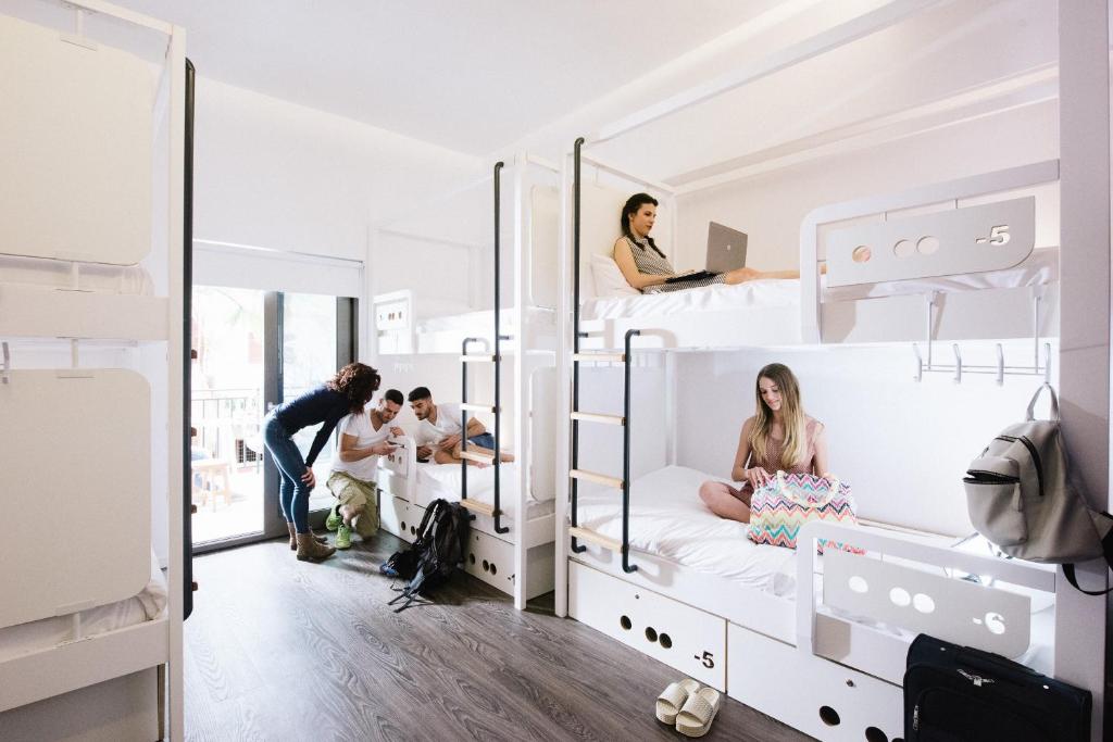 a group of people in bunk beds in a room at Cocoon City Hostel in Chania