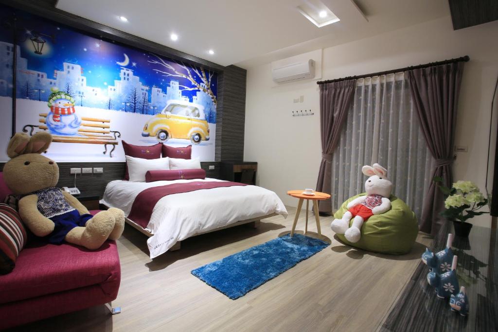 a bedroom with a bed with stuffed animals in it at Early Summer in Luodong