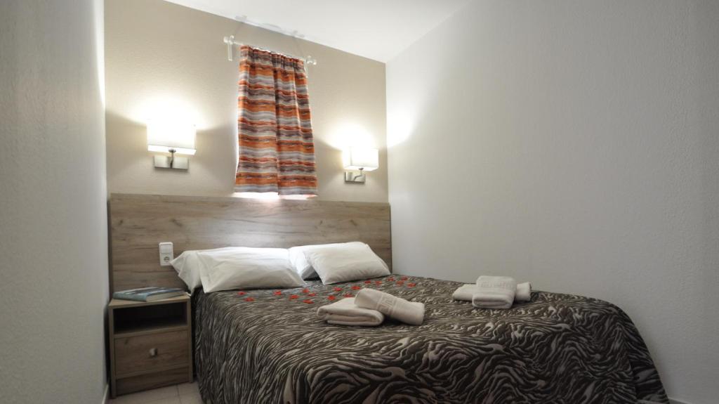 Postel nebo postele na pokoji v ubytování Aparthotel Safari