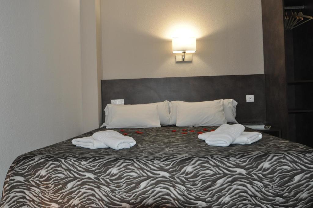 Postel nebo postele na pokoji v ubytování Aparthotel Safari