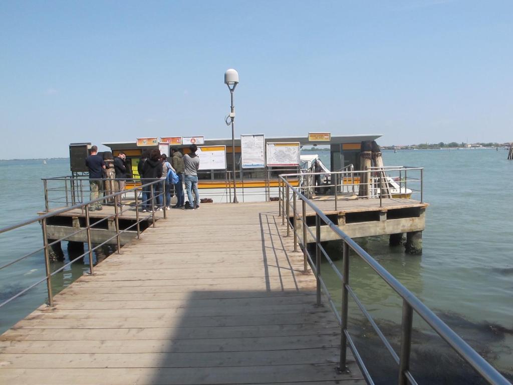 a group of people standing on a pier at Casa Di PrimaVera in Venice