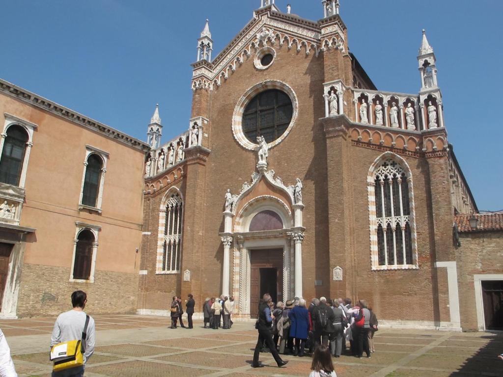 a group of people walking in front of a church at Casa Di PrimaVera in Venice