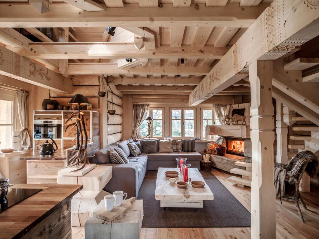 a living room with a couch and a fireplace at GORSKA OSADA Lovely Chalets Zakopane in Poronin