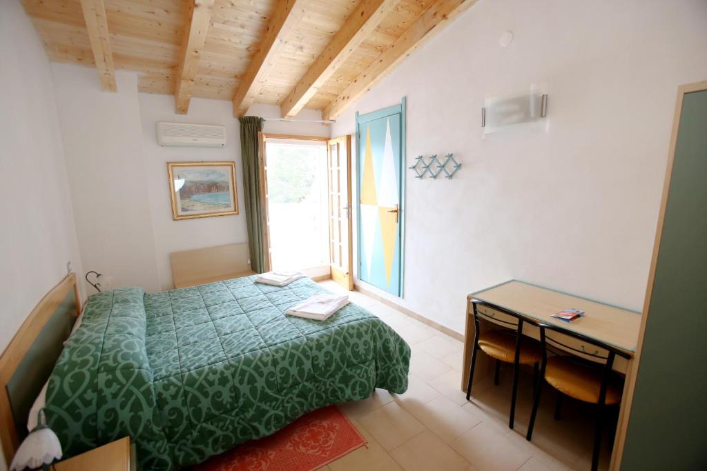 Postel nebo postele na pokoji v ubytování Hotel Paola
