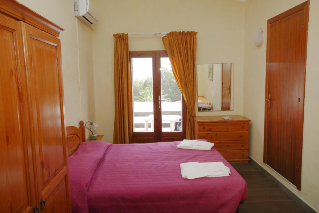 Postel nebo postele na pokoji v ubytování Hotel Paola