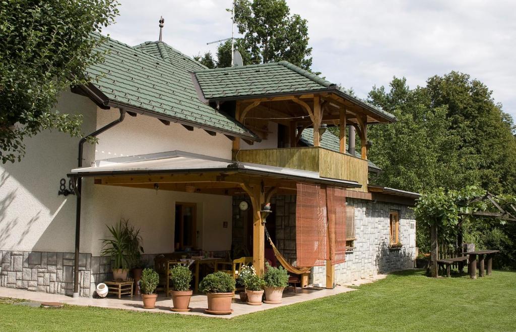 a house with a pavilion on the side of it at Apartma Obrh in Smarjeske Toplice
