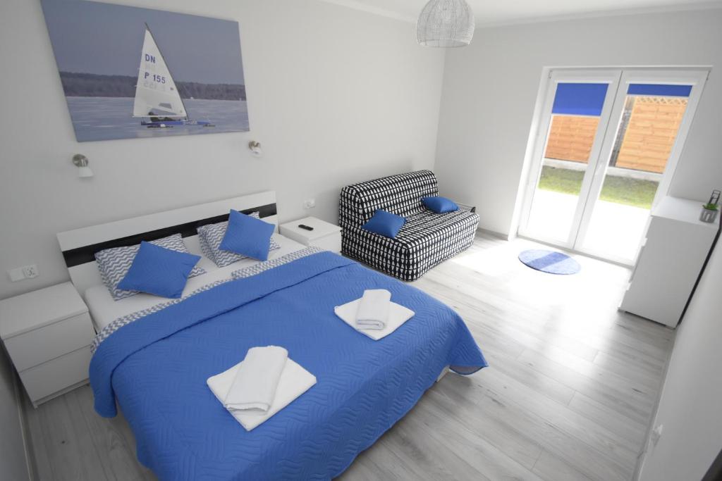 Posteľ alebo postele v izbe v ubytovaní Mazuria Apartamenty