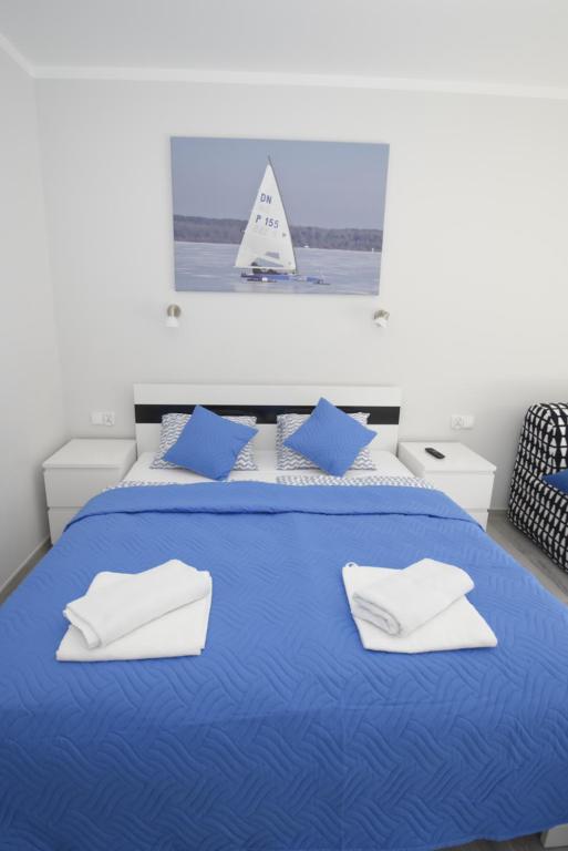 Posteľ alebo postele v izbe v ubytovaní Mazuria Apartamenty