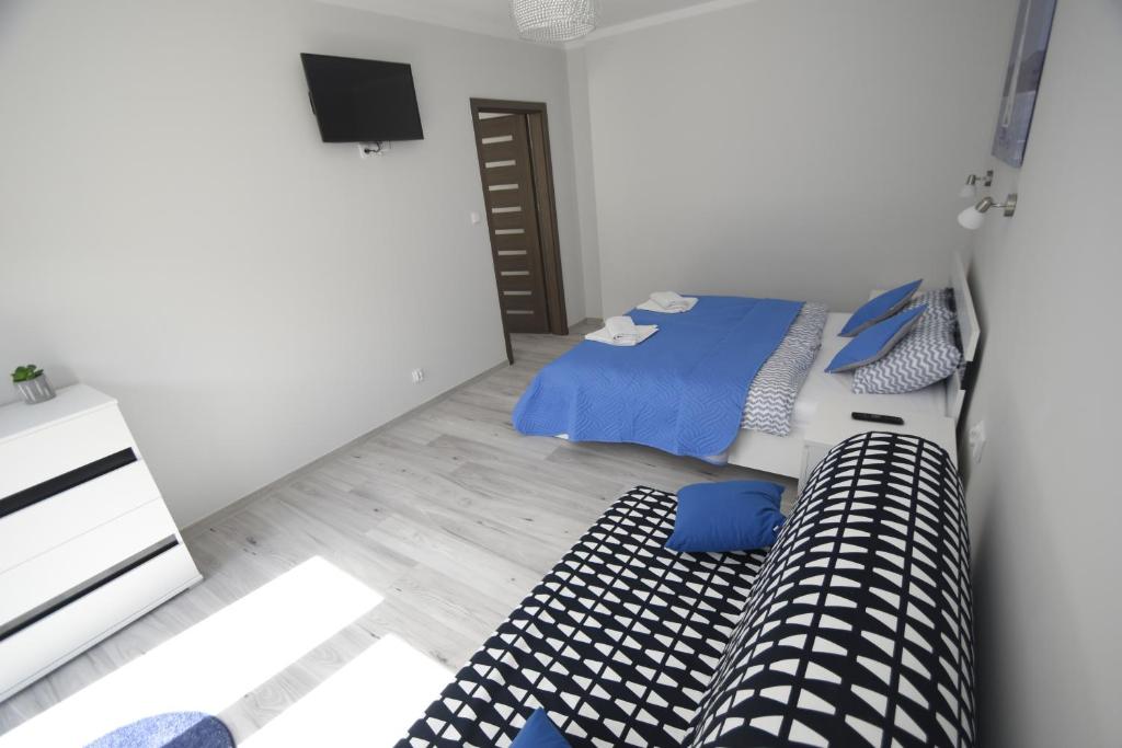 Posteľ alebo postele v izbe v ubytovaní Mazuria Apartamenty