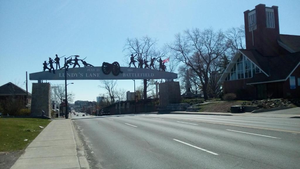 a street sign that reads it was the last inhabited at 6267 Persepolis Inn in Niagara Falls