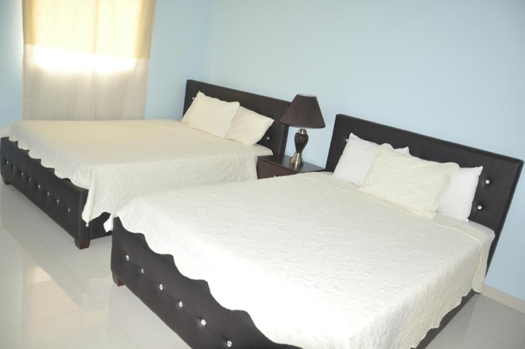 Postel nebo postele na pokoji v ubytování Sams Hotel