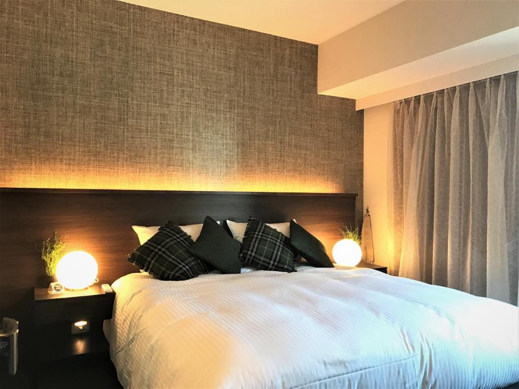 Postel nebo postele na pokoji v ubytování R&Run Kyoto Serviced Apartment & Suites