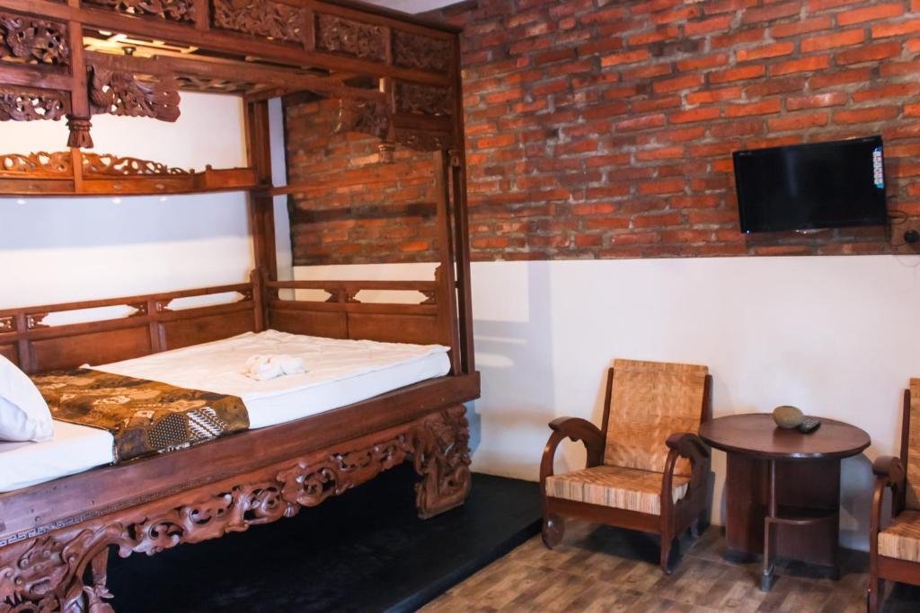 Postel nebo postele na pokoji v ubytování Griya Gribig Guest House Mitra RedDoorz