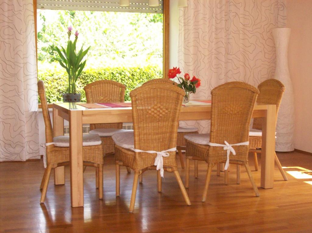 a dining room table and chairs with a table and a window at Ferienhaus Irger in Marquartstein