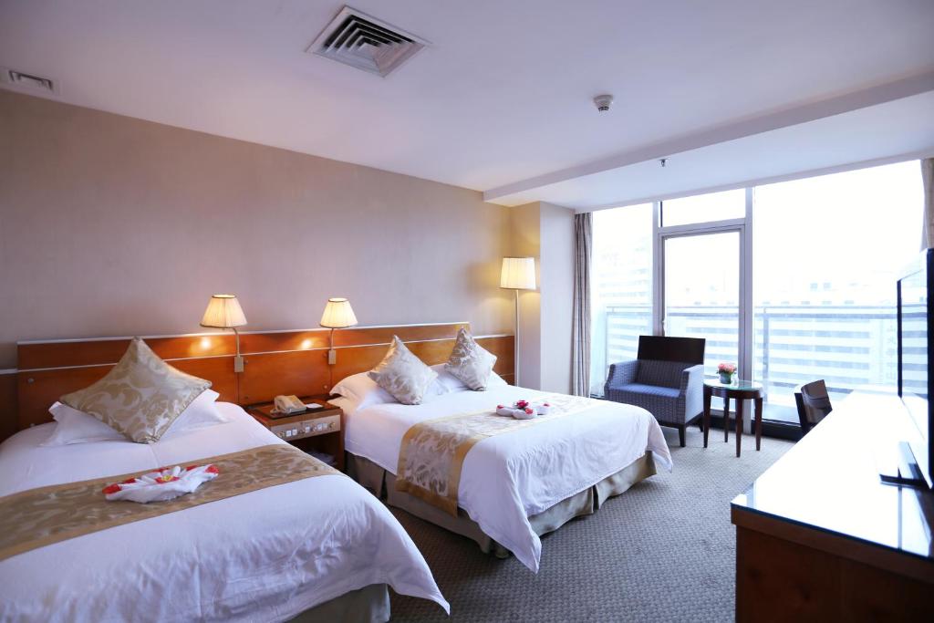 Postel nebo postele na pokoji v ubytování Yihe Hotel Ouzhuang