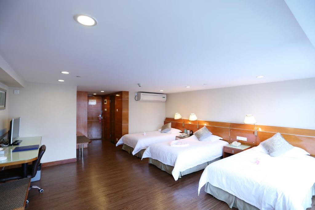 Postel nebo postele na pokoji v ubytování Yihe Hotel Ouzhuang