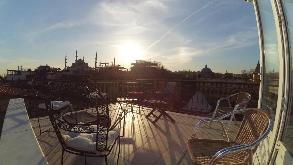 a balcony with chairs and a view of a city at Guest House - Grandma's House in Istanbul