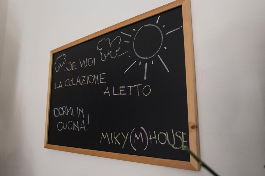 a chalkboard with writing on it on a wall at Miky M House B&B in Cagliari