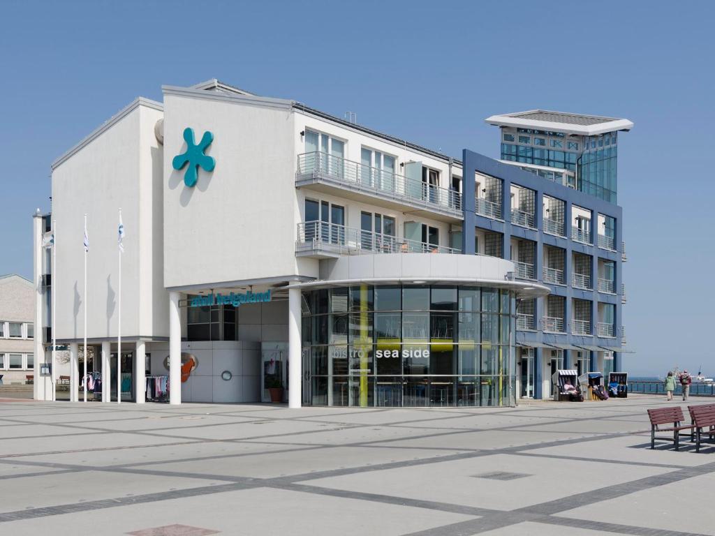 un gran edificio blanco con una flor azul en atoll apartments, en Helgoland