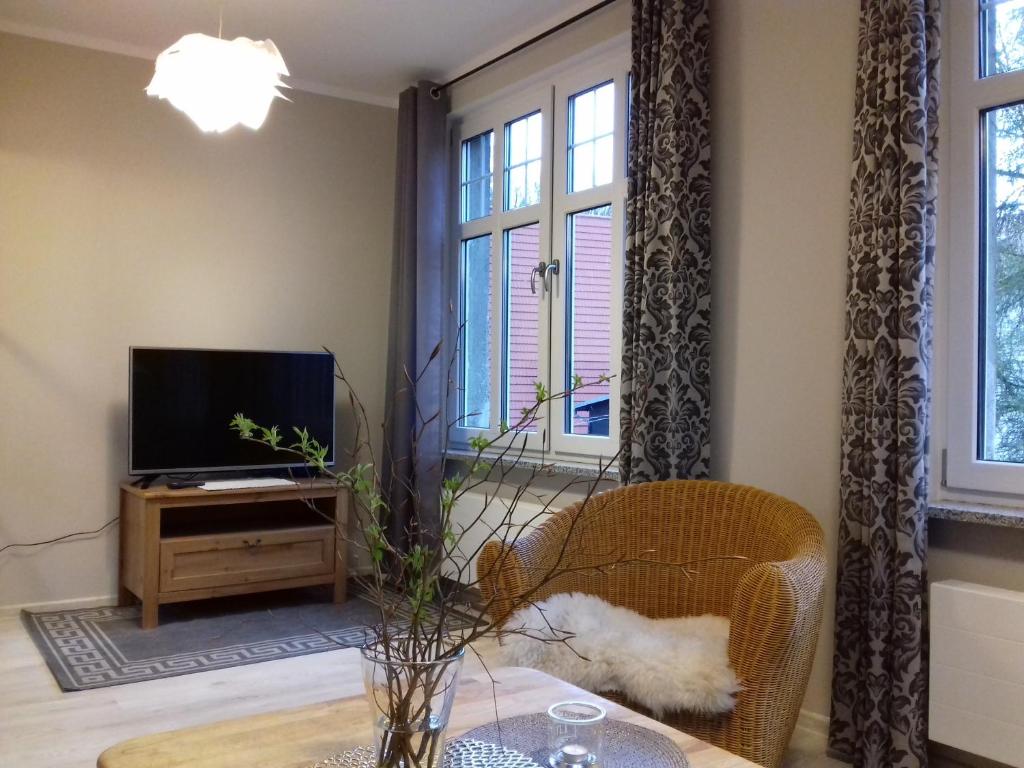 a living room with a tv and a table at Na Prusa in Szklarska Poręba