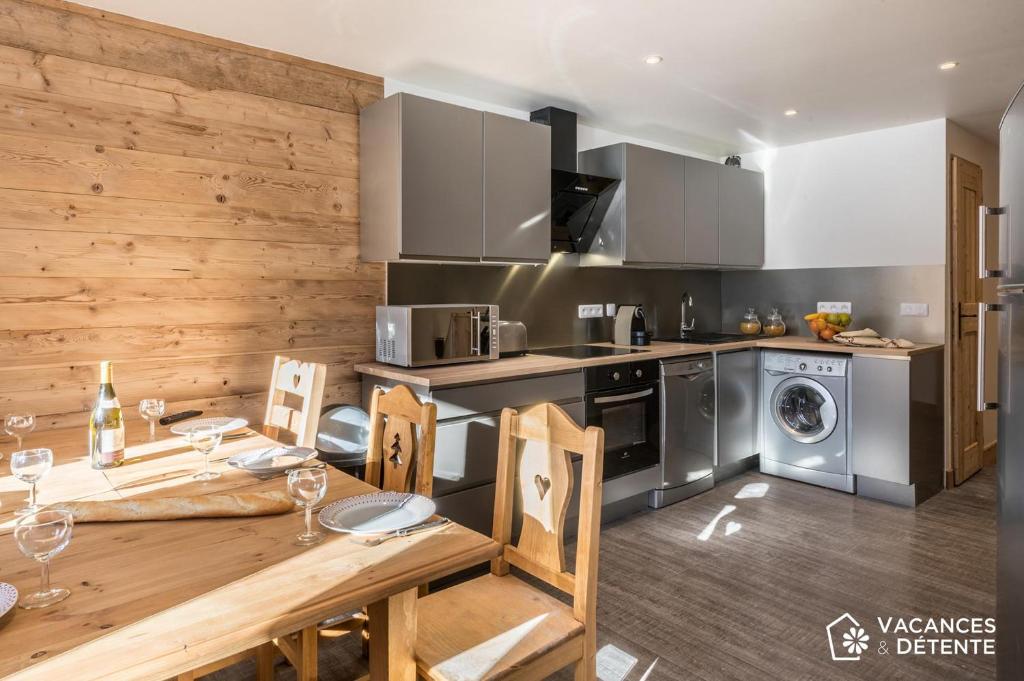 a kitchen with a table and a dining room at Nazca C8 in Val Thorens