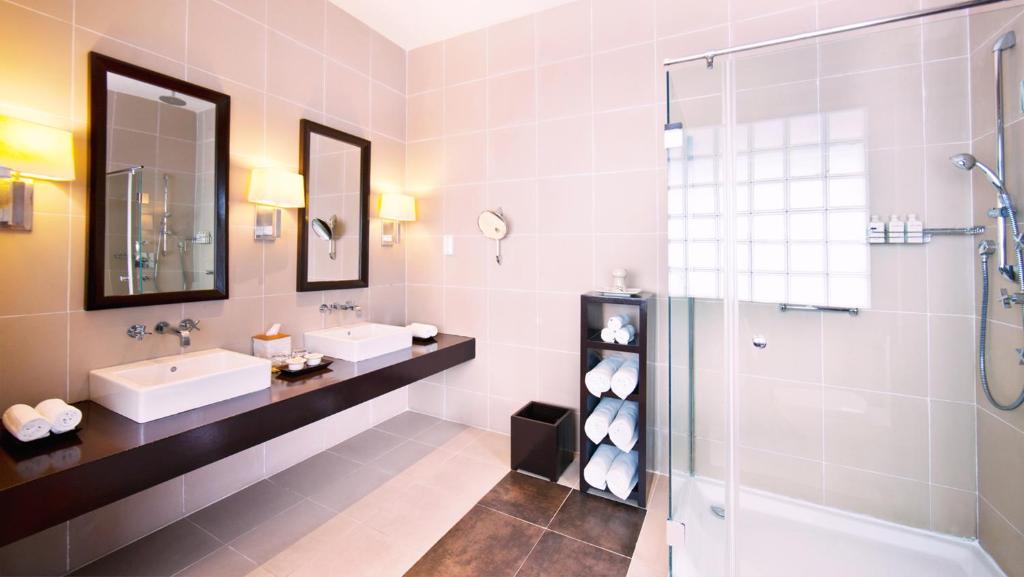 a bathroom with two sinks and a shower at Adaaran Prestige Water Villas - with Dine around Premium All inclusive - 24 hours in Raa Atoll