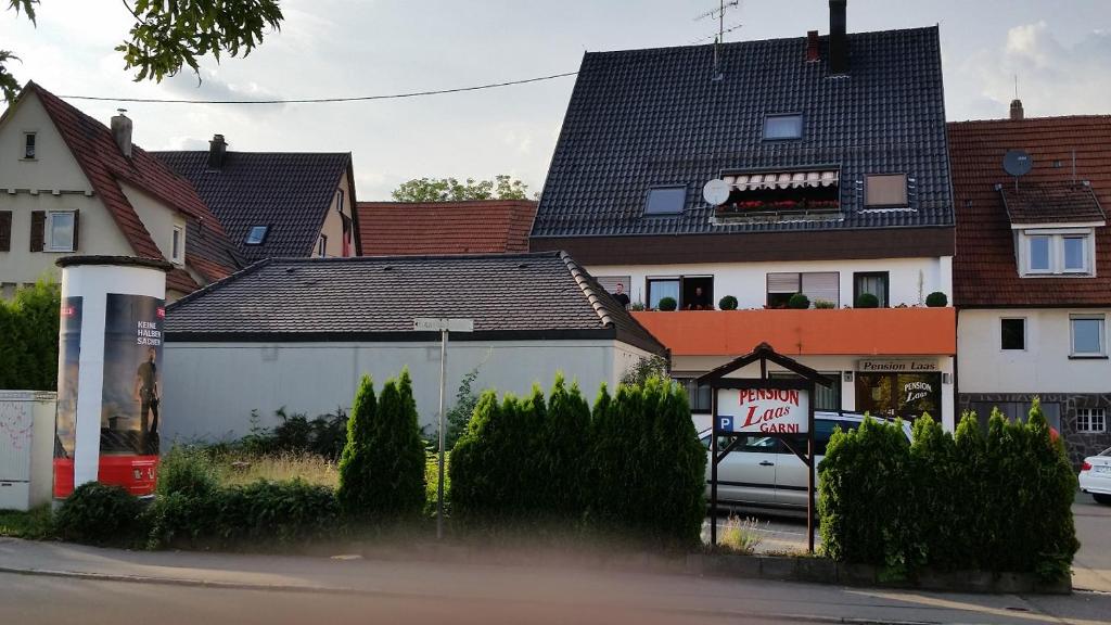 a house in a residential neighborhood with houses at Pension Laas in Ostfildern