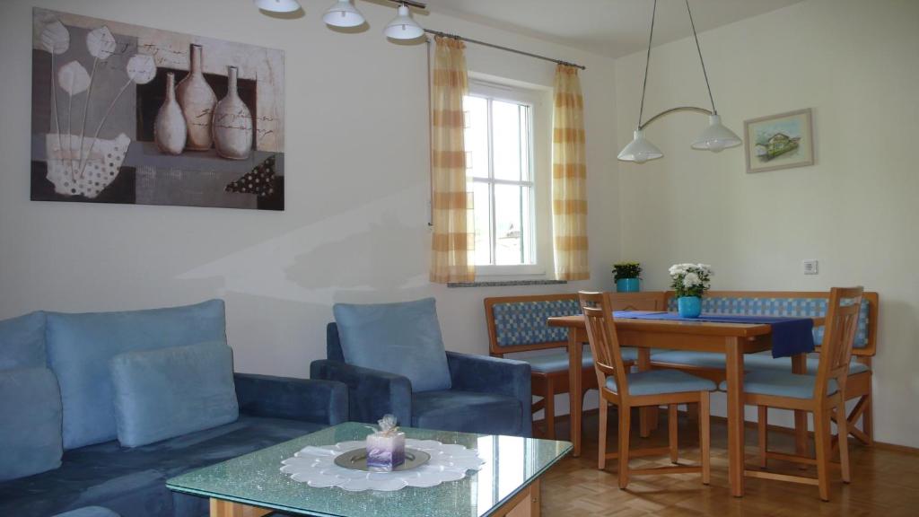 a living room with blue chairs and a table at Apartment Rudi in Garmisch-Partenkirchen